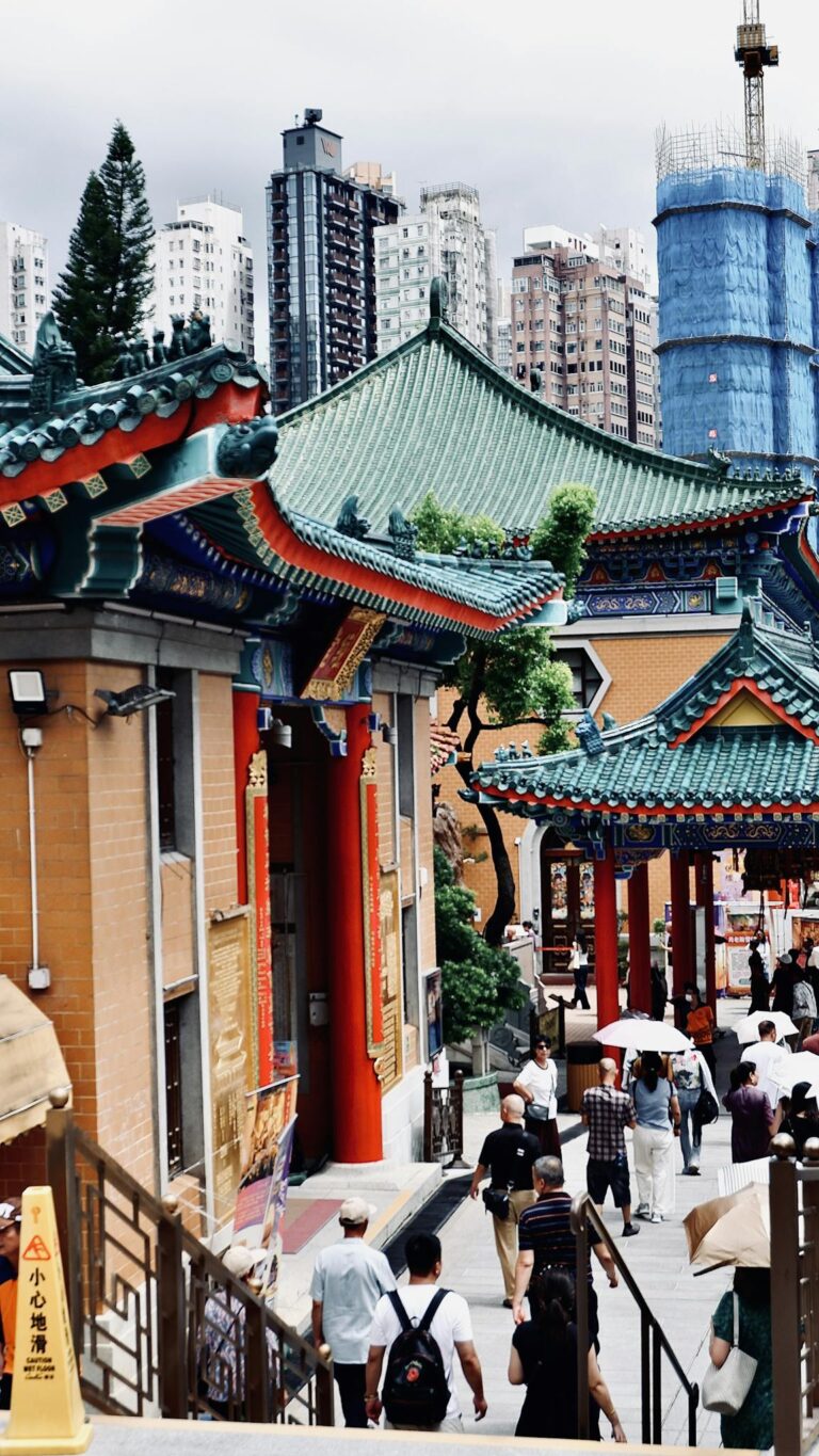 Explore the bustling architecture and cultural atmosphere of Wong Tai Sin Temple in Kowloon, Hong Kong.